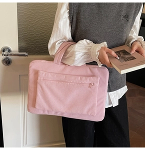 Detailed texture of pink corduroy laptop tote bag with a front zipper pocket