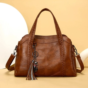 Brown retro PU leather tote bag with woven handles and cute metal cat tassel charm
