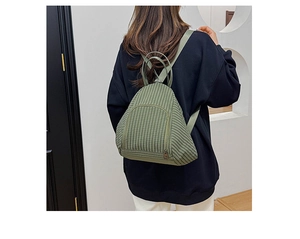 Detail of green plaid patterned dumpling bag showing unique water drop shape and dual handles