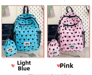 Close-up of polka dot backpack set in light blue and pink with drawstring storage bags