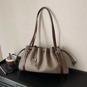 Retro pleated khaki tote bag with slender brown straps and leather petal charm detail