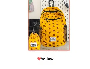 Detailed set of yellow polka dot backpack with matching drawstring storage pouch