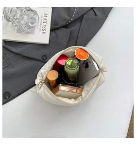 Detail of white quilted cloud makeup bag showing spacious interior and storage capacity