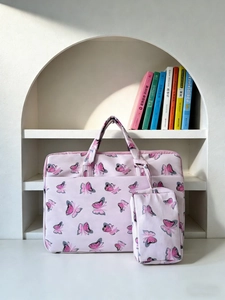 Detailed view of the pink butterfly print shoulder bag and matching small pouch