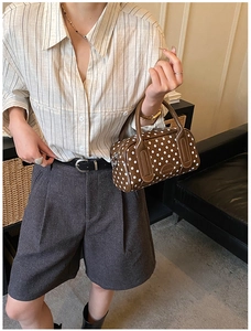 Polka dot caramel brown Boston bag styled with a minimalist beige striped shirt outfit
