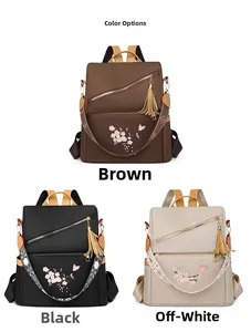 Trois sacs à dos en tissu Oxford avec broderie florale et détails de pompons