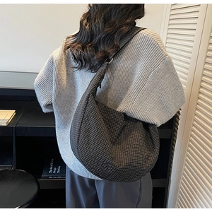 Detalle del patrón de cuadros blancos y negros en un bolso hobo de gran capacidad