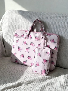 Close-up of pink butterfly print shoulder bag and matching pouch on soft sofa