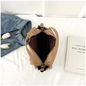 Detail of khaki nylon tote bag interior with zipper closure and spacious compartment