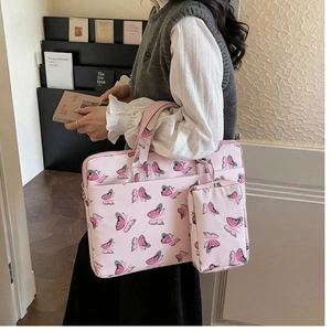 Detailed view of pink butterfly print laptop bag and matching accessory pouch set
