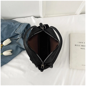 Top-down view of black nylon tote bag with leather handles and spacious interior
