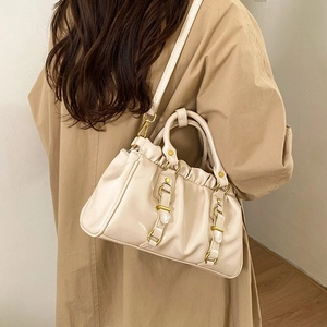 Cream pleated tote bag with gold hardware and adjustable strap shown on shoulder
