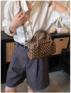Polka dot Boston handbag detail with double handles and glossy coffee brown finish