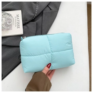 Light blue quilted cloud makeup bag with soft texture and metallic zipper closure