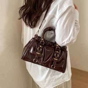 Retro burgundy patent leather tote bag with pleated design and gold metal hardware