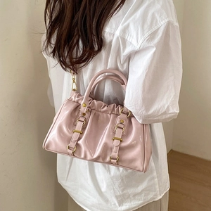 Pink glossy patent leather tote bag with vintage pleated cloud design and golden rivets