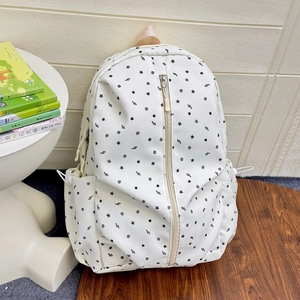Close-up of starry musical note pattern on durable white nylon school backpack