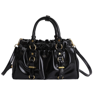 Retro black patent leather tote bag with pleated top and golden ring hardware accents