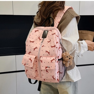 Sac à dos rose pour femme avec nœuds et pois et breloque ours pour un style tendance