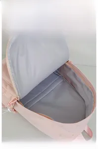 Internal display of pink backpack showing grey fabric lining and large storage space