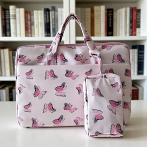 Close-up of pink butterfly velvet laptop bag and matching accessory storage pouch set
