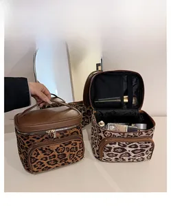 Macro detail of large capacity leopard print toiletry bag with brush slots and dual metal zippers