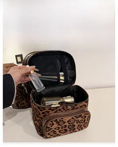 Internal view of high-capacity leopard print makeup bag with compartments for brushes