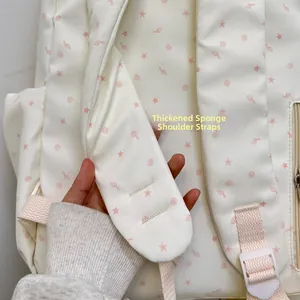 Detail view of the thickened sponge shoulder straps on the cream star print backpack