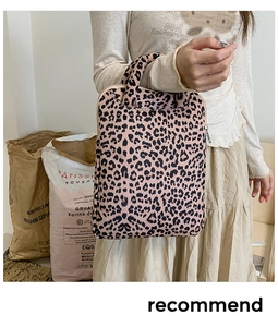 Close-up of leopard print tote bag made of thick canvas with top handle and zipper