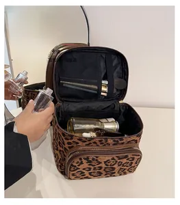 Detail view of leopard print cosmetic bag with compartments for brushes and bottles