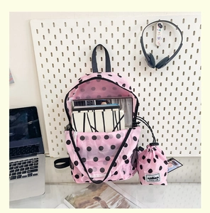 Detailed set view of pink polka dot backpack with a matching drawstring storage bag