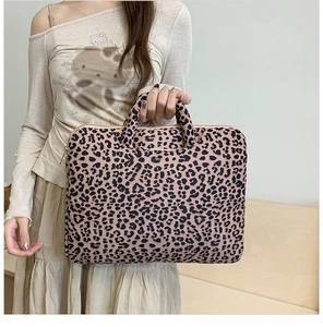 Detail of pink leopard print tote bag with reinforced handles and zipper closure