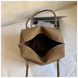 Macro shot of large capacity brown calfskin handbag interior with top zipper and texture