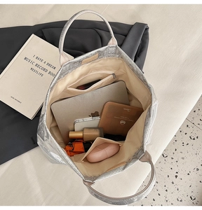 Interior view of large silver snakeskin tote bag showing spacious compartments and storage