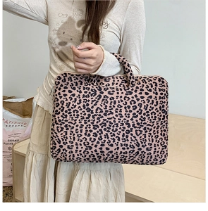 Close-up of leopard print laptop bag with smooth metal zipper and durable carry handle