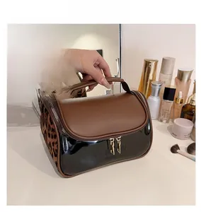 Detail of the leopard print travel vanity case with gold zippers and sturdy top handle