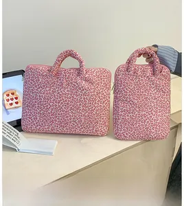 Detailed view of pink leopard print laptop sleeves in horizontal and vertical styles