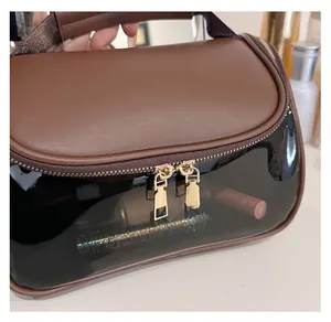Detail view of the smooth dual gold metal zippers and handle on the PU cosmetic travel bag