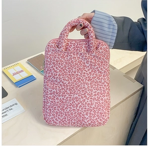 Detailed view of pink leopard print laptop sleeve with thick fabric and zip closure