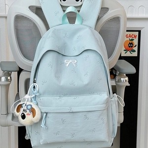 Light blue bow-print backpack for students with a cute white puppy plush keychain charm