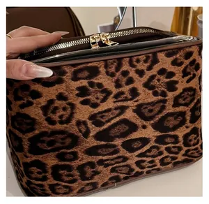 Detail of leopard print toiletry bag featuring soft faux fur fabric and golden dual zippers