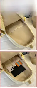 Internal view of a light yellow backpack showing spacious compartments and laptop sleeve