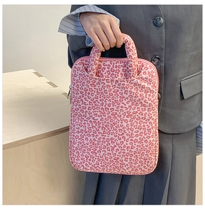 Detail of pink leopard print laptop sleeve with sturdy handle and secure zipper closure