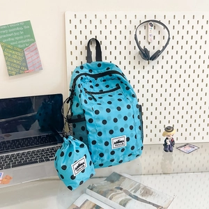 Close-up of light blue polka dot backpack set with grid texture and matching pouch