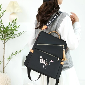 Sac à dos noir pour femme en tissu oxford avec broderie cerisier et bandoulière large mode