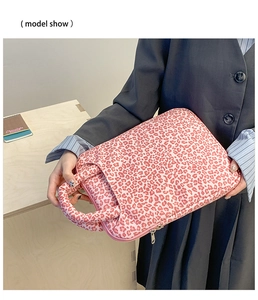 Close-up of pink leopard print laptop sleeve with padded nylon and durable top handle