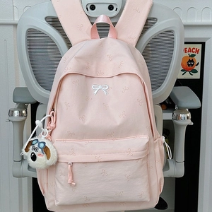Pink backpack with bow embroidery and a cute puppy plush charm for students