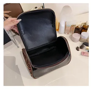 Internal view of a leopard print travel makeup bag showing spacious open compartment