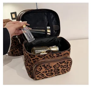 Detailed interior of leopard print makeup bag showing brush slots and mesh pockets