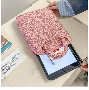 Detail of pink leopard print laptop sleeve showing zipper closure and soft tablet storage